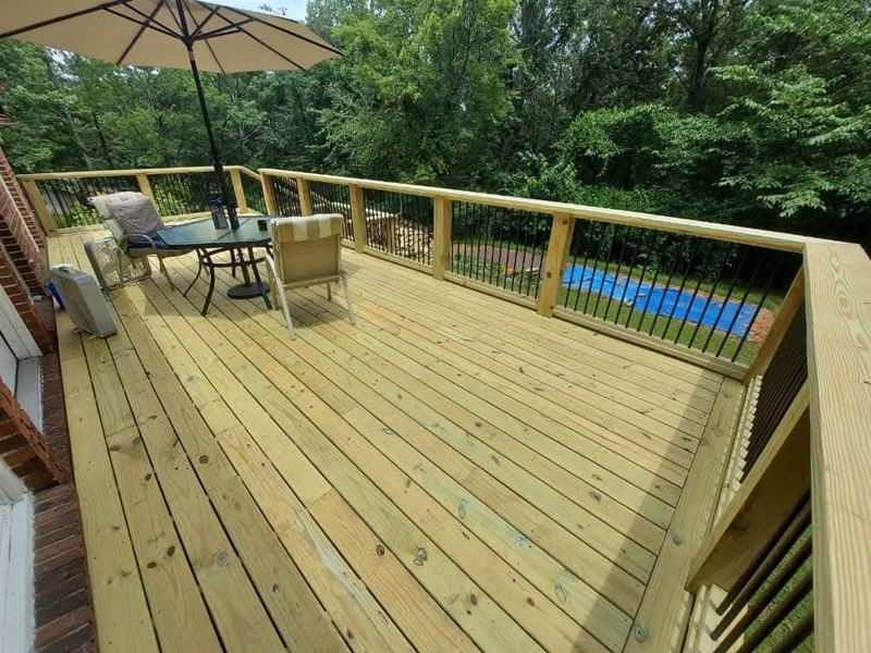 New pressure-treated deck overlooking a pool